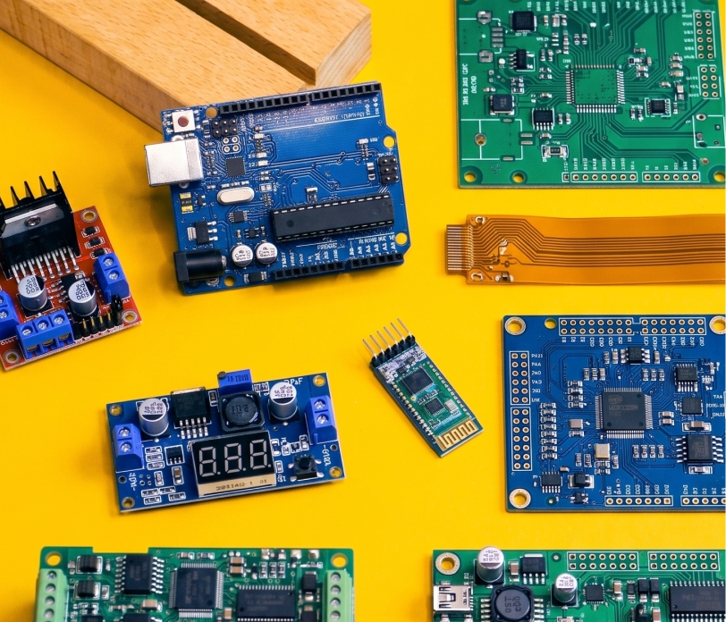 Close up of hands soldering components on a board